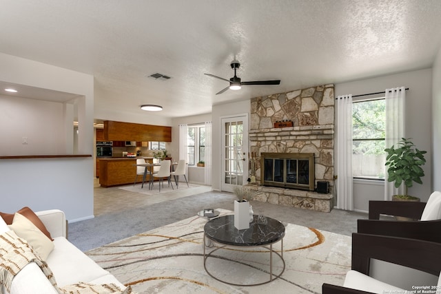 19750 Encino Way, San Antonio, TX 78259 - carpeted living area featuring plenty of natural light, a textured ceiling, ceiling fan, baseboards, and a stone fireplace