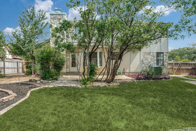 19750 Encino Way, San Antonio, TX 78259 - back of house featuring stone siding, a chimney, stucco siding, and central AC unit
