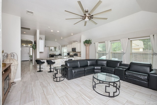 living area featuring visible vents, ceiling fan, and lofted ceiling
