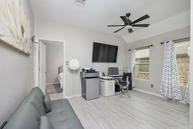 home office with baseboards, ceiling fan, vaulted ceiling, and visible vents