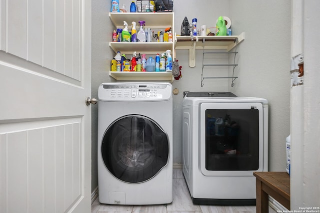 washroom featuring laundry area and washing machine and dryer