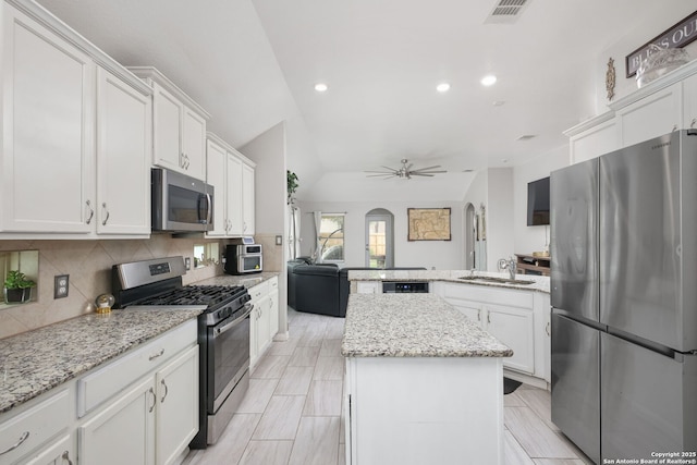 kitchen featuring white cabinets, appliances with stainless steel finishes, a peninsula, recessed lighting, and visible vents