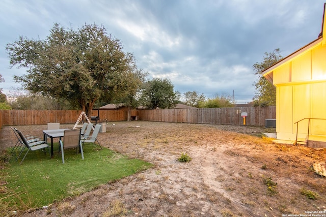 view of yard featuring a fenced backyard and central AC