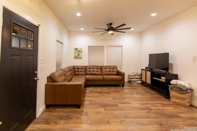 living room with a ceiling fan, baseboards, recessed lighting, and wood finished floors