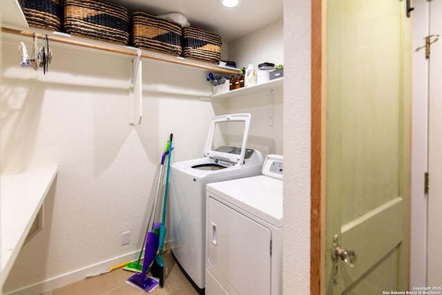 washroom featuring laundry area, washing machine and dryer, light tile patterned floors, baseboards, and recessed lighting
