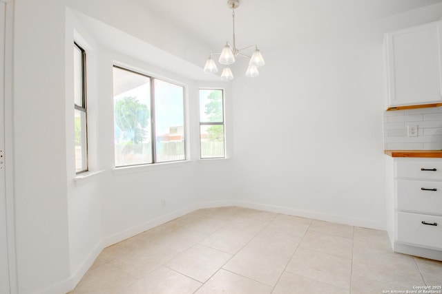 4742 Misty Run, San Antonio, TX 78217 - unfurnished dining area featuring baseboards, a chandelier, and light tile patterned floors