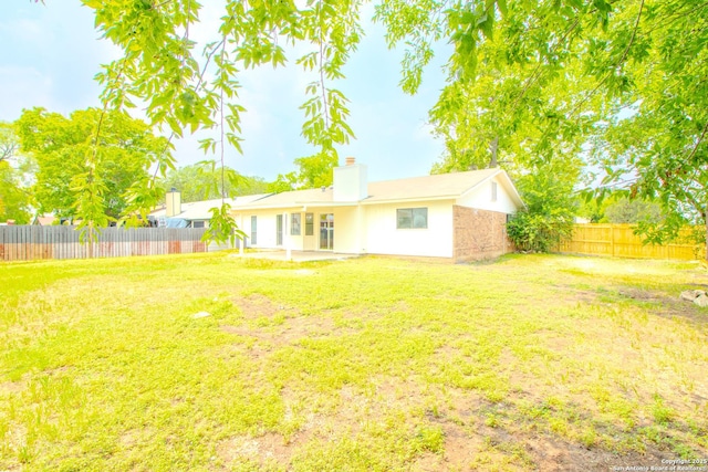 4742 Misty Run, San Antonio, TX 78217 - back of property with a patio, a fenced backyard, a lawn, and a chimney