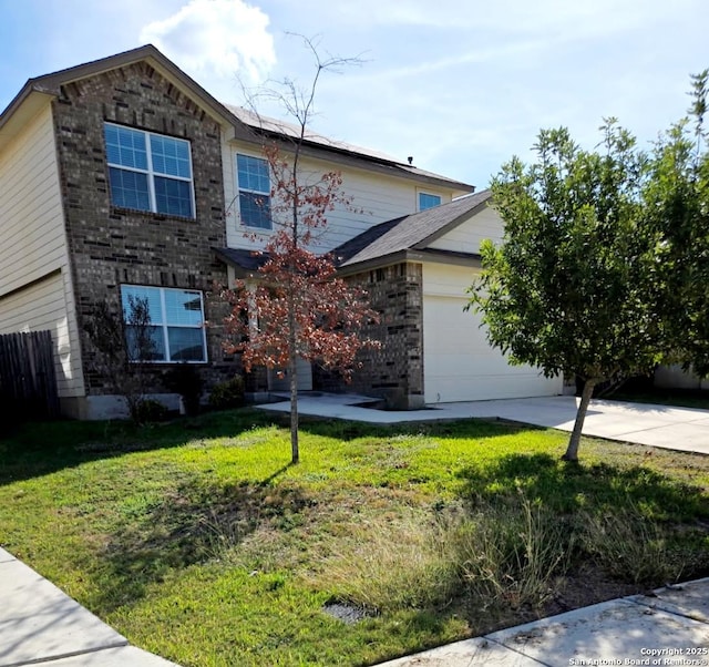 view of front of house featuring an attached garage, brick siding, driveway, and a front yard
