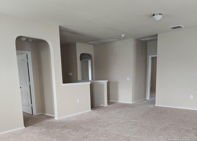 empty room with baseboards, carpet, and visible vents