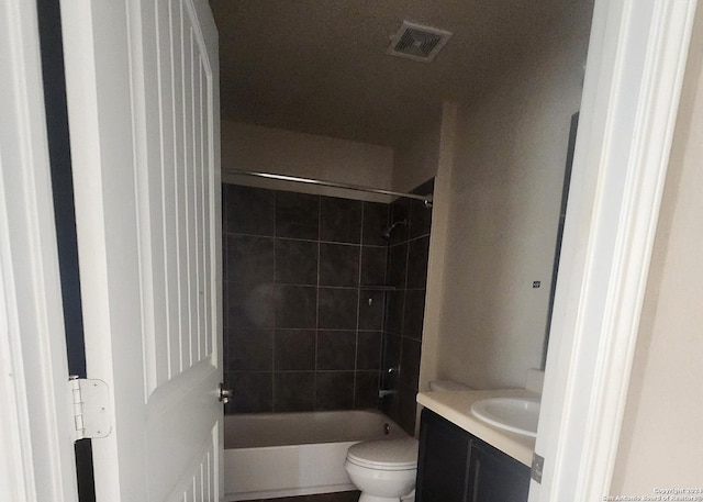 bathroom featuring visible vents, shower / washtub combination, toilet, and vanity