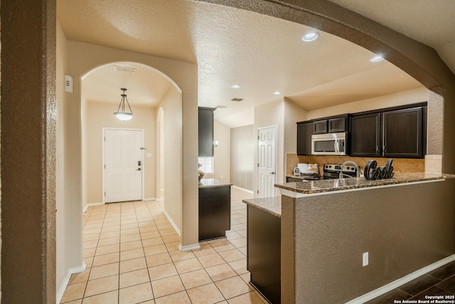 3830 Bogie Way, Converse, TX 78109 - kitchen with light tile patterned flooring, appliances with stainless steel finishes, arched walkways, stone counters, and visible vents