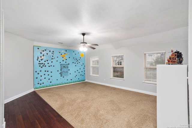 unfurnished room with baseboards, a ceiling fan, and hardwood / wood-style floors