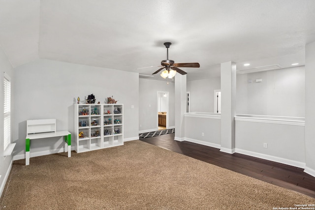 interior space featuring dark wood-style flooring, baseboards, ceiling fan, and attic access