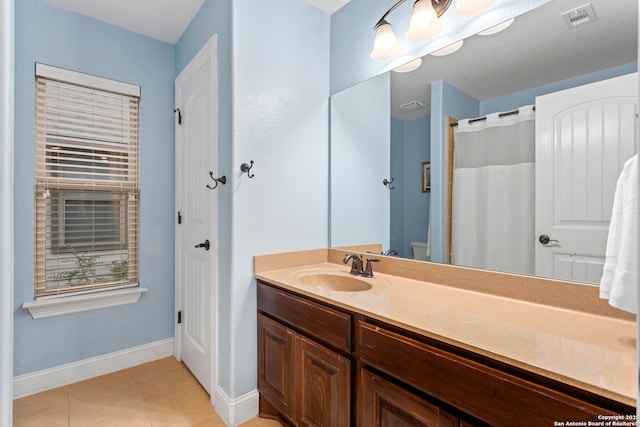 full bath featuring visible vents, tile patterned flooring, vanity, baseboards, and toilet