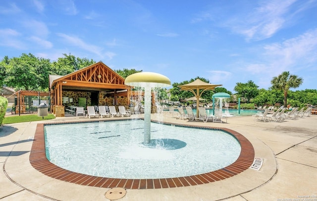 community pool with a patio, a gazebo, and fence