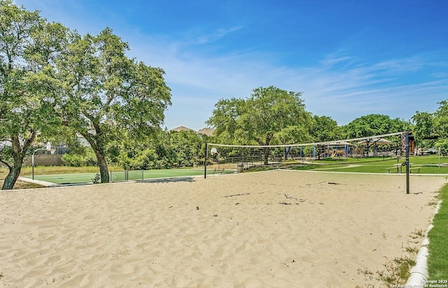 view of home's community featuring a lawn and volleyball court