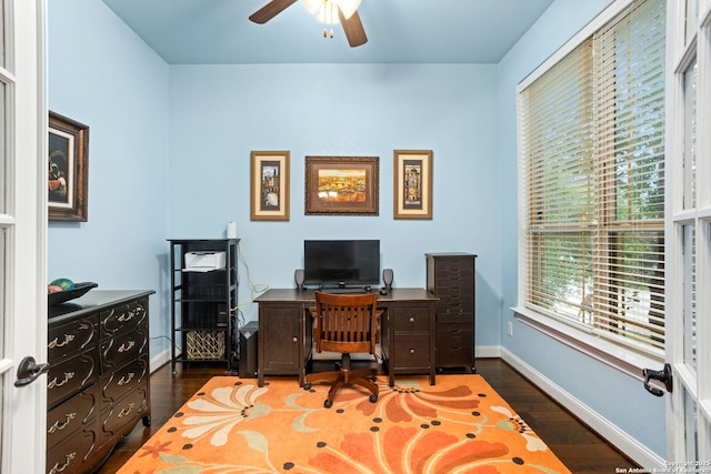 office featuring baseboards, ceiling fan, wood finished floors, and a wealth of natural light