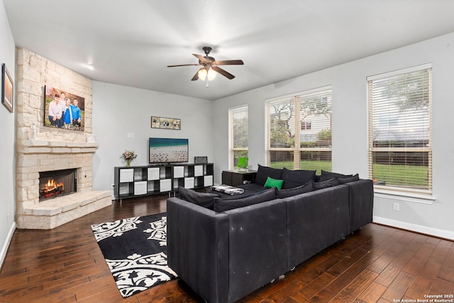 living area with wood-type flooring, baseboards, ceiling fan, and a healthy amount of sunlight