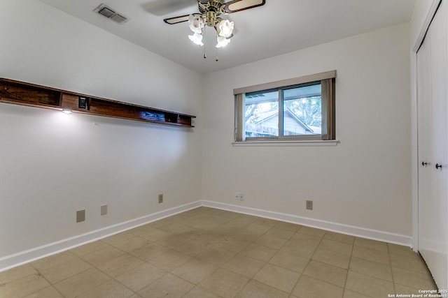 unfurnished room featuring a ceiling fan and baseboards