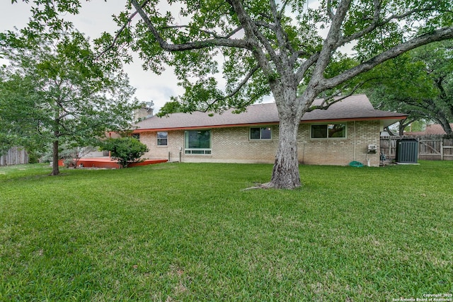 back of property featuring brick siding and cooling unit