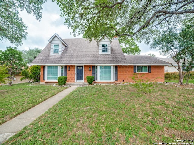 9327 Fernglen Dr, San Antonio, TX 78240 - new england style home with roof with shingles, a front yard, and brick siding
