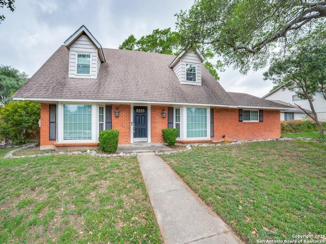 9327 Fernglen Dr, San Antonio, TX 78240 - cape cod-style house with a shingled roof, a front yard, and brick siding