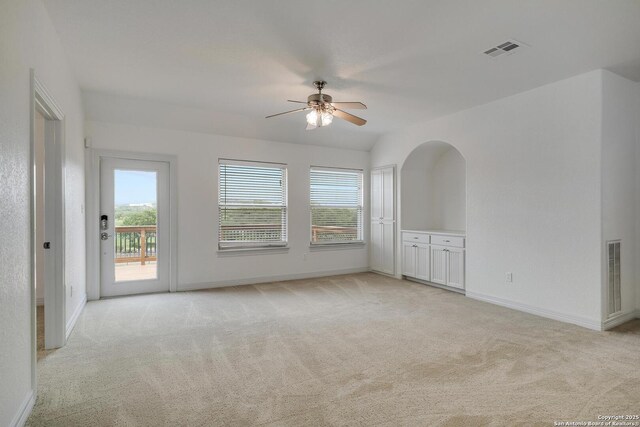 spare room featuring a ceiling fan, baseboards, light colored carpet, and visible vents