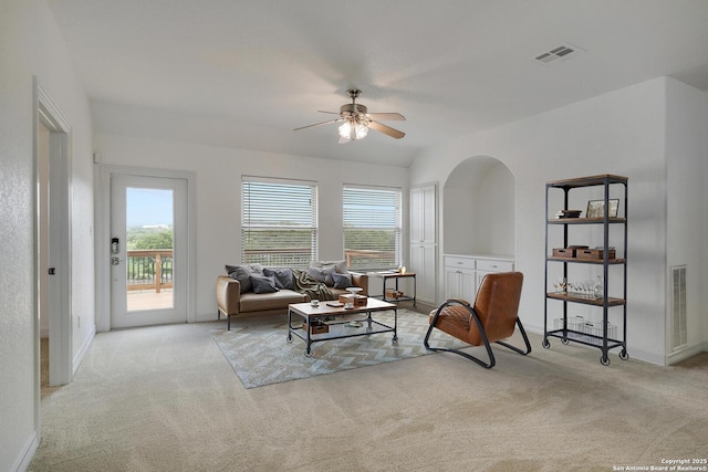 living room featuring visible vents, a ceiling fan, carpet, and baseboards