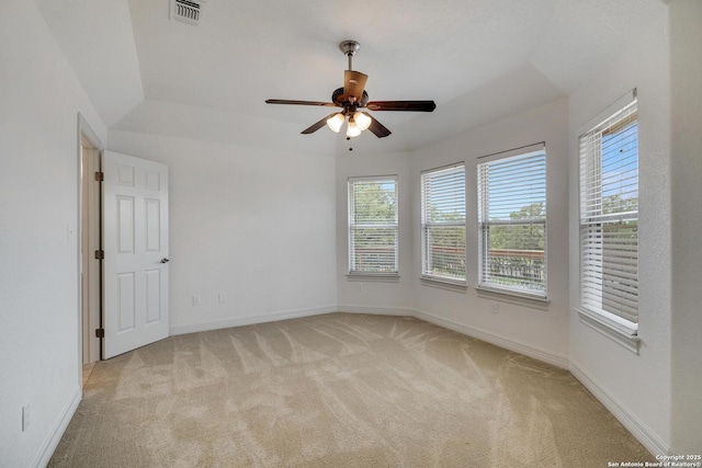 unfurnished room with light colored carpet, ceiling fan, visible vents, and baseboards