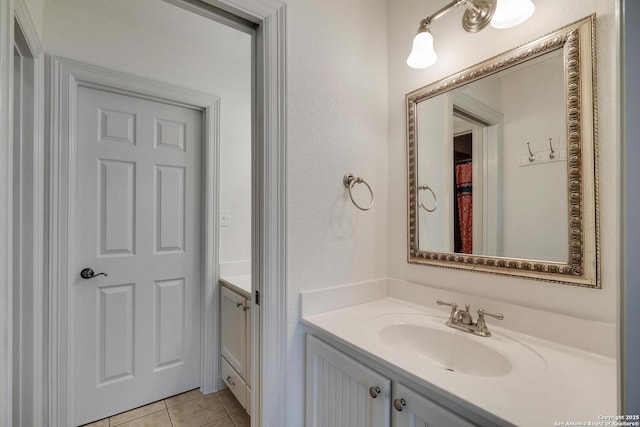 bathroom featuring tile patterned flooring and vanity
