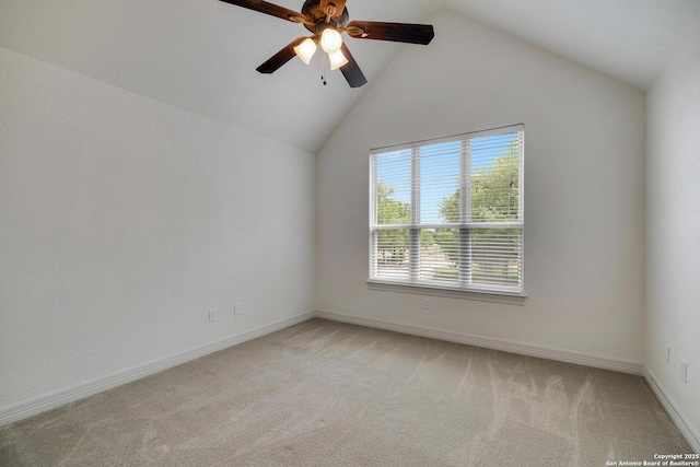 empty room with baseboards, light carpet, a ceiling fan, and lofted ceiling