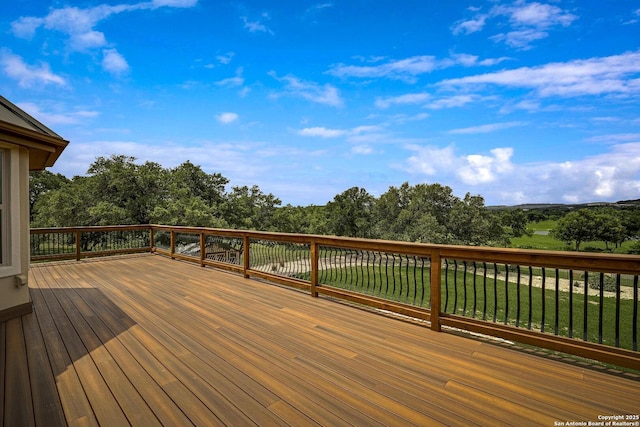 wooden deck with a lawn