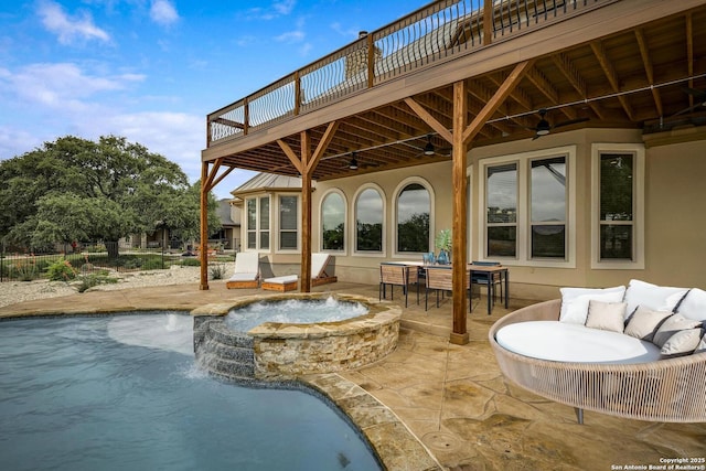 exterior space featuring a pool with connected hot tub, a wooden deck, stucco siding, a ceiling fan, and a patio