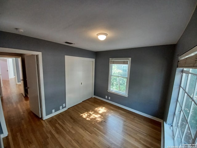 111 Blue Bonnet Blvd, Alamo Heights, TX 78209 - unfurnished bedroom featuring baseboards, wood finished floors, visible vents, and a closet