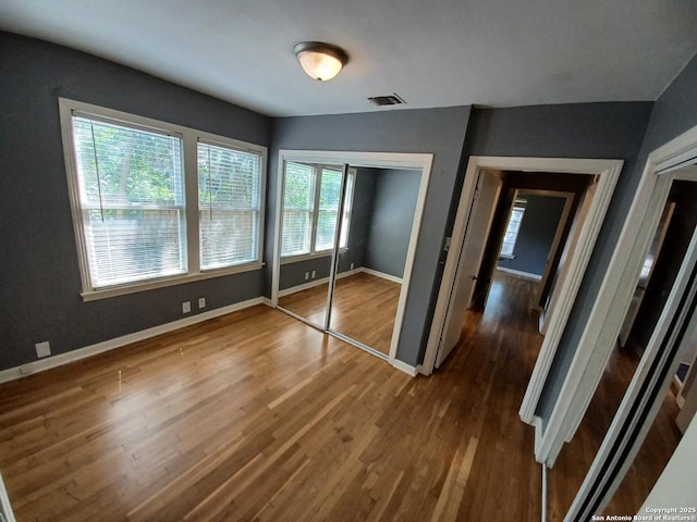 111 Blue Bonnet Blvd, Alamo Heights, TX 78209 - unfurnished bedroom featuring baseboards, a closet, wood finished floors, and visible vents