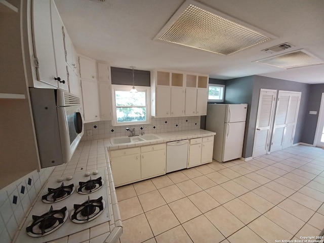 111 Blue Bonnet Blvd, Alamo Heights, TX 78209 - kitchen featuring visible vents, decorative backsplash, white appliances, tile countertops, and a sink