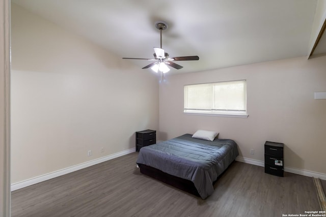 bedroom featuring baseboards, ceiling fan, and wood finished floors