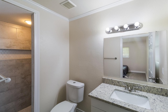 ensuite bathroom featuring visible vents, ornamental molding, vanity, toilet, and tiled shower
