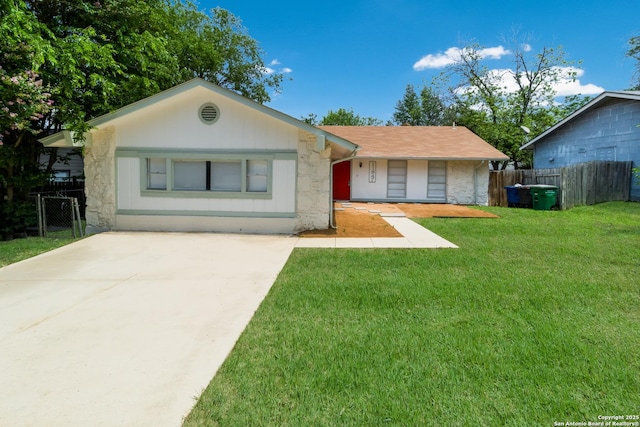 single story home featuring a front lawn, fence, driveway, and stone siding