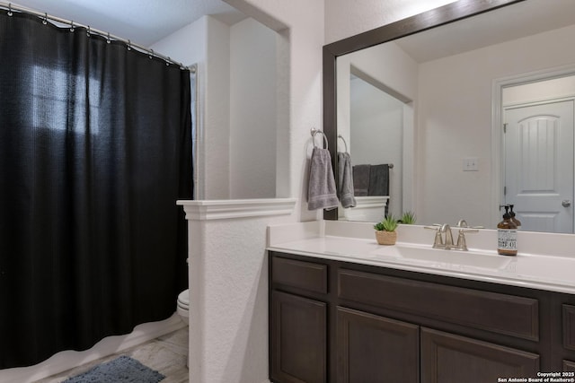 full bathroom featuring vanity and toilet