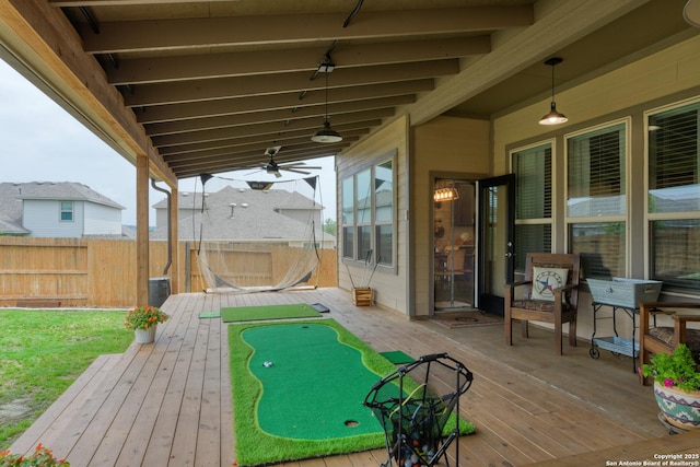 deck with a ceiling fan and fence