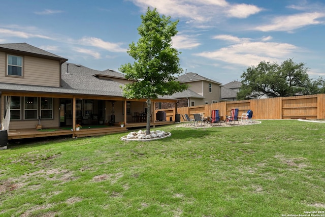 view of yard with fence, a fire pit, a deck, and a patio area