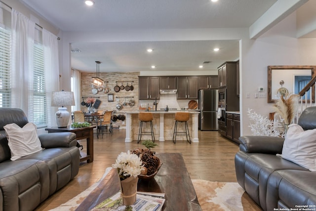 living room featuring a healthy amount of sunlight, recessed lighting, and wood finished floors