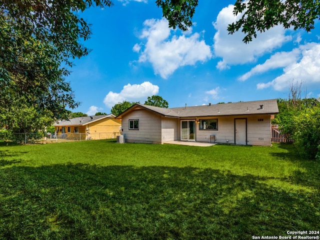 back of property with a patio, a fenced backyard, a yard, and cooling unit