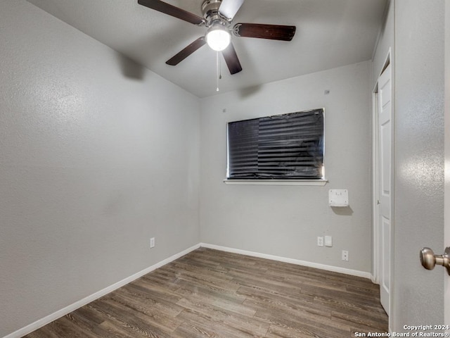 unfurnished room featuring baseboards, ceiling fan, and wood finished floors