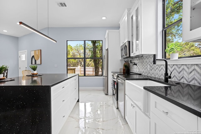 kitchen featuring visible vents, appliances with stainless steel finishes, tasteful backsplash, baseboards, and marble finish floor