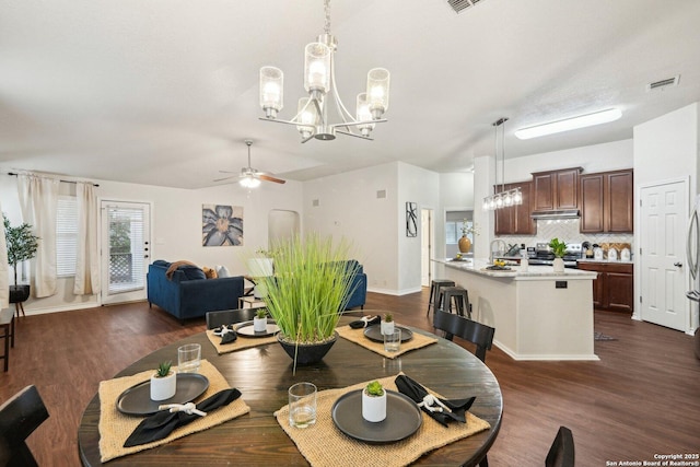 3022 Sunday Song, San Antonio, TX 78245 - dining area with baseboards, ceiling fan with notable chandelier, dark wood finished floors, and visible vents