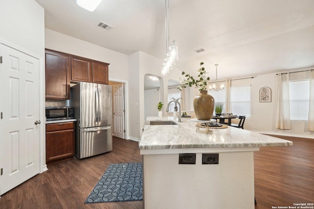 3022 Sunday Song, San Antonio, TX 78245 - kitchen featuring appliances with stainless steel finishes, a sink, dark wood finished floors, visible vents, and pendant lighting
