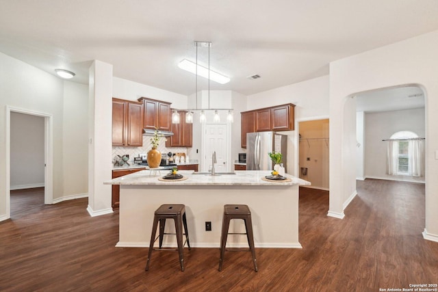 3022 Sunday Song, San Antonio, TX 78245 - kitchen with freestanding refrigerator, dark wood-style floors, decorative backsplash, and a sink