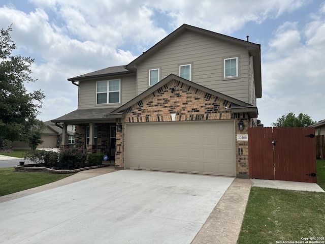 view of front facade with fence, brick siding, a garage, a gate, and concrete driveway